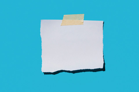 Torn blank paper on blue background. New york City, New York State, United States