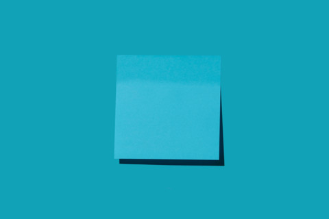 Blank blue post it note on blue background. New york City, New York State, United States