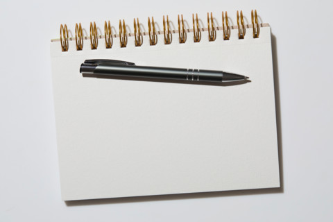 Blank notebook and pen on white background. New york City, New York State, United States