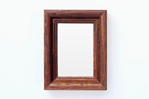 Wooden picture frame on white background. New york City, New York State, United States