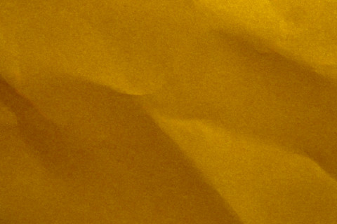 Close-up of yellow wrinkled paper. New York City, New York State, United States