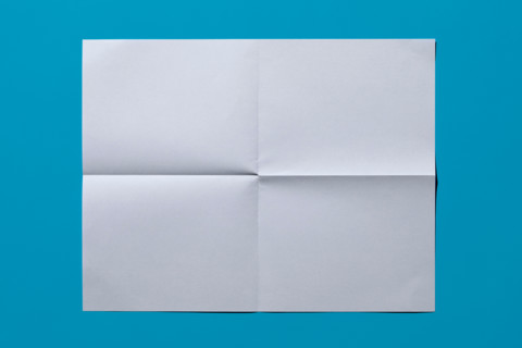 White sheet of paper on blue background. New York City, New York State, United States
