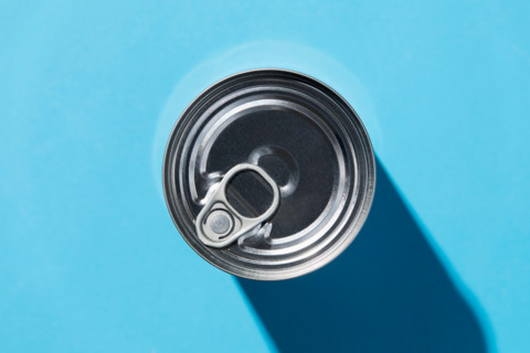 Overhead view of tin can on blue background. New York City, New York State, United States