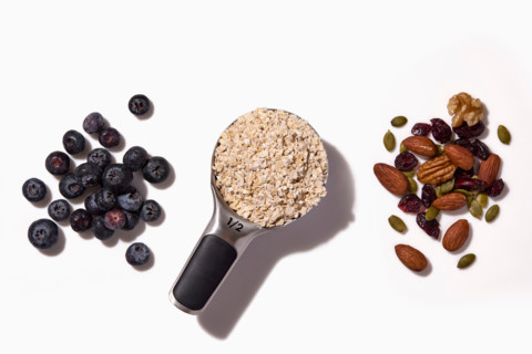 Raw oats, blueberries and nuts on white background. New York City, New York State, United States