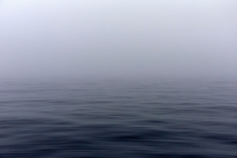 Calm Pacific Ocean in fog. Kodiak, Alaska, United States