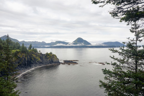 Sea coast with mountains in distance. Kodiak, Alaska, United States