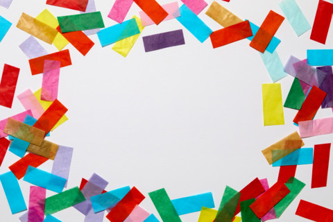Colorful confetti on white background. New York City, New York State, United States