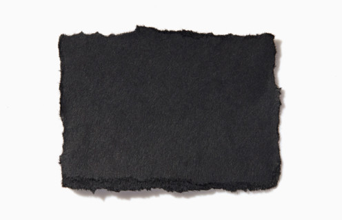 Torn black paper on white background. New York City, New York State, United States