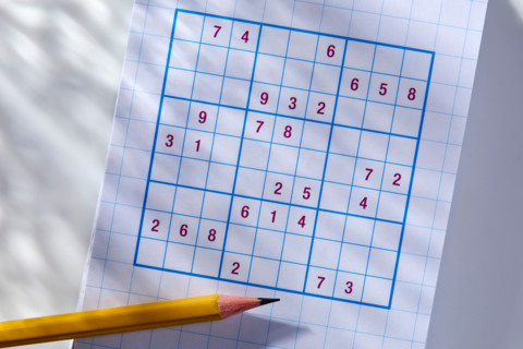 Pencil on sudoku puzzle in sunlight. New York City, New York State, United States