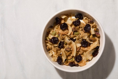 Overhead view of bowl of granola with yogurt. New York City, New York State, United States