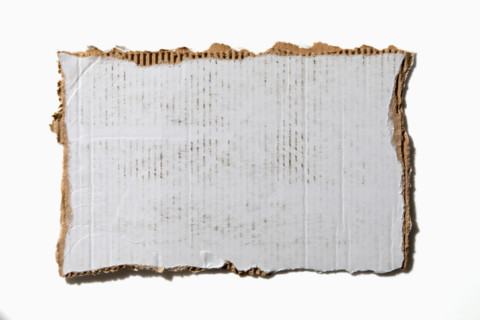 Torn white cardboard on white background. New York City, New York State, United States