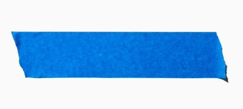 Ripped blue painters tape on white background. New York City, New York State, United States