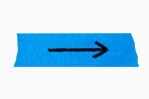 Black arrow on torn blue painters tape on white background. New York City, New York State, United