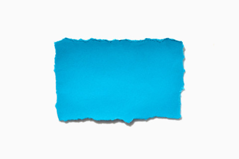 Torn blue Paper on white background. New York City, New York State, United States