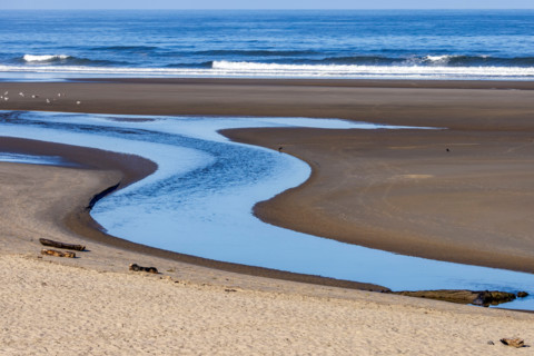 S-shaped Ecola Creek flowing into Pacific Ocean. Cannon Beach, Oregon, United States