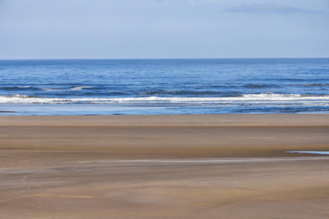 Empty beach and calm ocean at dawn. Cannon Beach, Oregon, United States