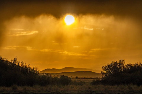 Sun below heavy rain clouds. Bellevue, Idaho, United States