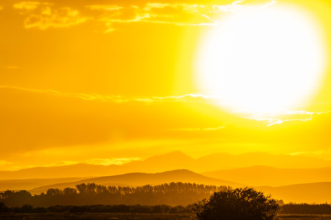 Setting sun glowing above hills. Bellevue, Idaho, United States