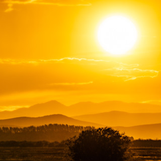 Setting sun glowing above hills. Bellevue, Idaho, United States