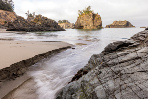 Creek running into ocean along Oregon Coast. Gold Beach, Oregon, United States