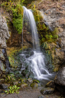 Waterfall running onto beach on Oregon Coast. Gold Beach, Oregon, United States