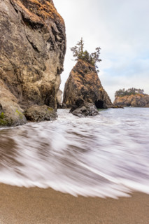Tide rises by sea stacks on Oregon Coast, blurred ocean. Gold Beach, Oregon, United States