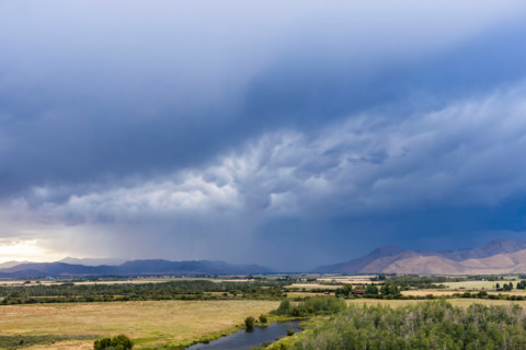 Dark storm clouds over fields and river. Bellevue, Idaho, United States