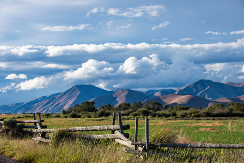 Fence in field with hills in background. Bellevue, Idaho, United States