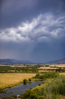 Dark storm clouds over fields and river. Bellevue, Idaho, United States