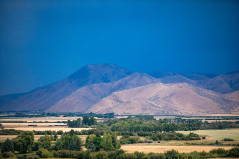 Dark storm sky over fields and hills. Bellevue, Idaho, United States