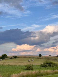 Clouds over fields with hay bales. Blacksburg, Virginia, United States