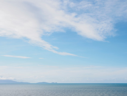 White delicate clouds above calm sea. Port Douglas, Queensland, Australia