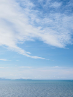 White delicate clouds above calm sea. Port Douglas, Queensland, Australia
