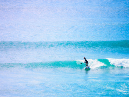Distant paddleboarder in vast blue sea. Sunshine Coast, Queensland, Australia