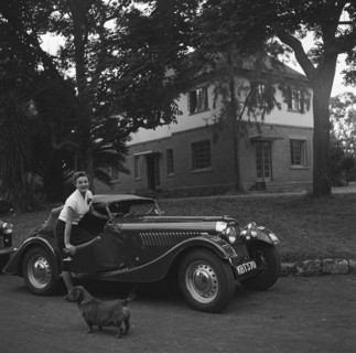 Mrs Douthwaite and car. Mrs Douthwaite and car pictured on the driveway of a large house. There is