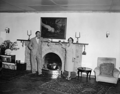 Roddy and Noreen. Roddy and his wife Noreen pose for a photograph leaning against a large fireplace
