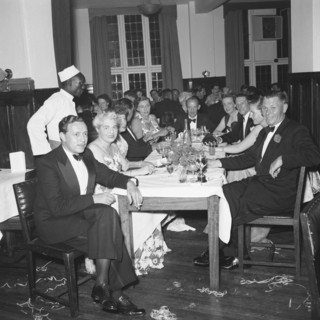 Motor sports dance. Formally dressed guests sit around tables enjoying drinks at a prize