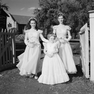 Three bridesmaids. Three bridesmaids at the Schofield-Sturman wedding pictured outside the entrance