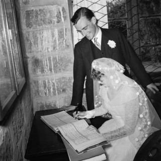 Signing the register. The newlywed Schofield-Sturman couple sign the marriage register at their