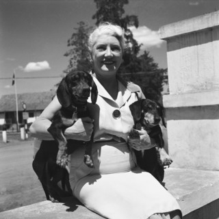 Mrs Keldie's dachshund dogs. Mrs Keldie sit outdoors holding her two pet dachshund dogs for the