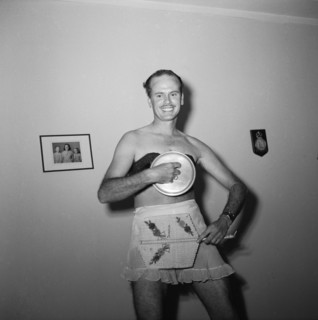 Fan handler. Ron Richardson performing a fan dance at the Archer's New Year party wearing only a