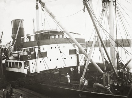 Unloading a bogie from SS Harmonides. Close up view of the cranes onboard SS Harmonides lowering a
