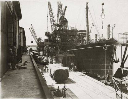 Loading grain on SS Modasa. SS Modasa docked at Kilindini harbour. Mombasa, Kenya, circa 1930.