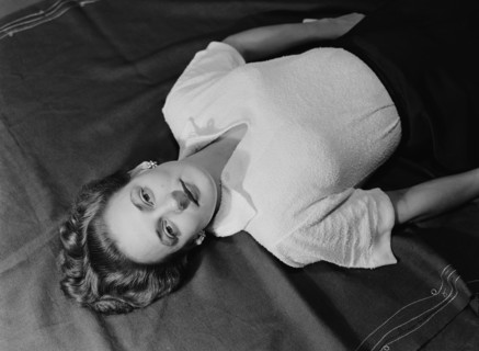 Cecily reclining. Cecily Gaueghan posing for a studio-style portrait. Kenya, 28 April 1953. Kenya,