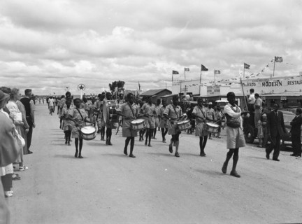 Maasai ngoma. Onlookers at a traditional 'ngoma' watch as a group of young Maasai people wearing