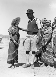 Barabaig chief with young women. A chief from the Barabaig tribe looks down on a young Barabaig