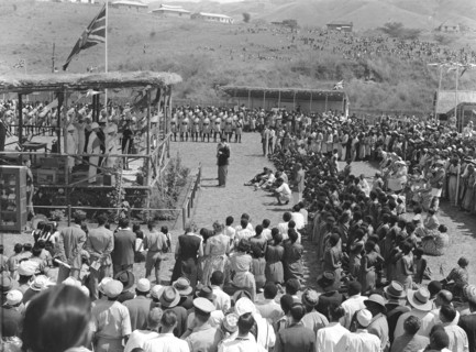 Mbeya show opening speech. A large, mixed race crowd watch the opening speech at the Mbeya show. A