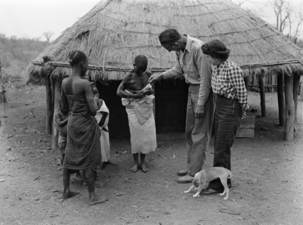 The Prices in Mozambique. An African family introduce their baby to a European couple, the Prices,
