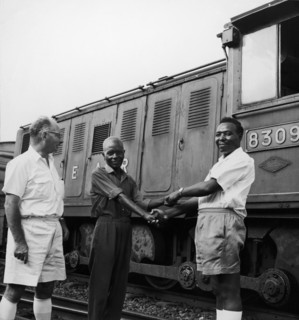Railway workers shake hands. A publicity photograph from the East African Railways and Harbours