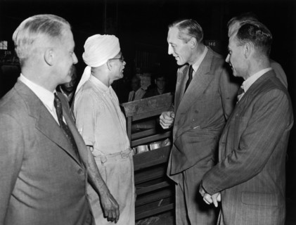 Sir Evelyn Baring talks to a railway worker. A publicity photograph from the East African Railways